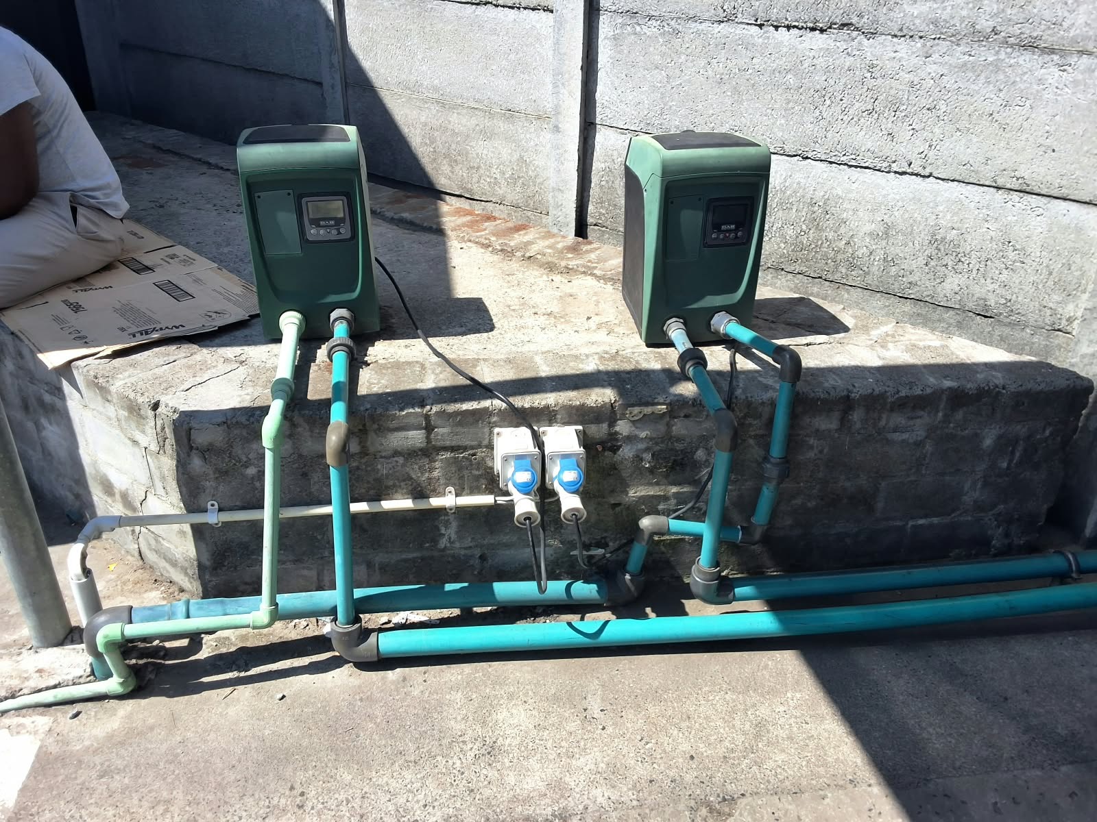 Two water pumps connected to exterior water supply pipes